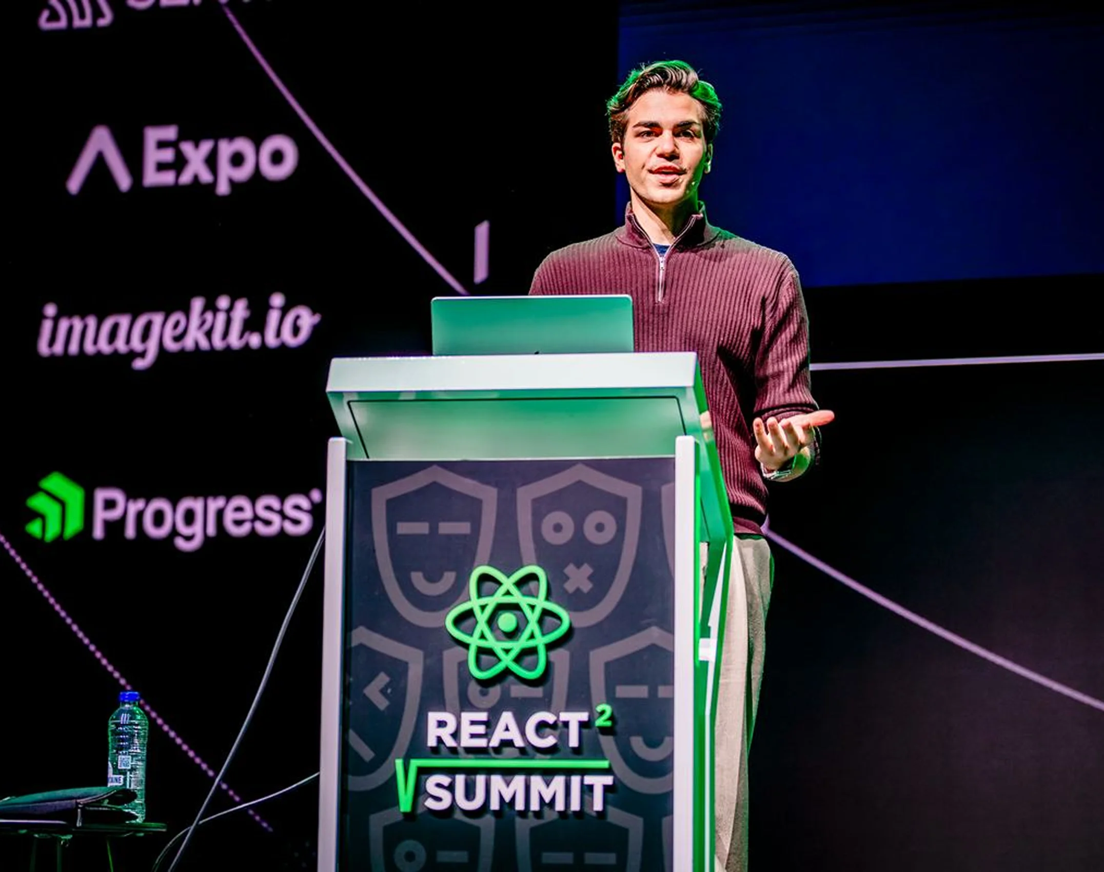 Adrian speaking on stage at React Summit